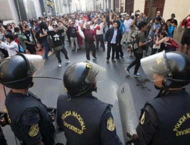 epa06405794 Riot police officers block the passage of protesters during a demonstration against the pardon to ex-president Alberto Fujimori, in Lima, Peru, 25 December 2017. Thousands of people demonstrated in the main cities of Peru against a medical pardon granted by Peruvian President Pedro Pablo Kuczynski to jailed former president Alberto Fujimori, who was serving a 25-year prison sentence for human rights abuses.  EPA/EDUARDO CAVERO