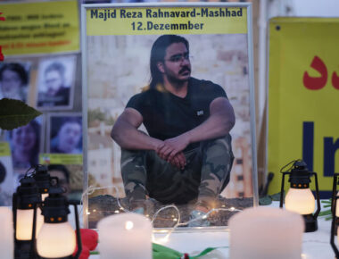 BERLIN, GERMANY - DECEMBER 12: A photograph of Majid Reza Rahnavard, 23, stands on a table among candles during a demonstration by supporters of the National Council of Resistance of Iran outside the German Foreign Ministry on December 12, 2022 in Berlin, Germany. Iranian authorities said Rahnavard was executed by hanging earlier today as punishment for killing two Iranian security members during recent street riots. Popular protests have been ongoing in Iran since the September death of Mahsa Amini.  (Photo by Sean Gallup/Getty Images)