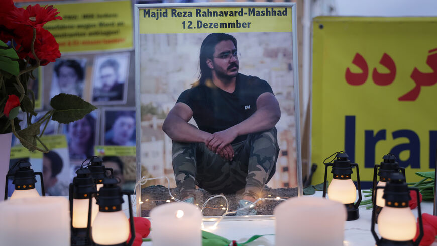 BERLIN, GERMANY - DECEMBER 12: A photograph of Majid Reza Rahnavard, 23, stands on a table among candles during a demonstration by supporters of the National Council of Resistance of Iran outside the German Foreign Ministry on December 12, 2022 in Berlin, Germany. Iranian authorities said Rahnavard was executed by hanging earlier today as punishment for killing two Iranian security members during recent street riots. Popular protests have been ongoing in Iran since the September death of Mahsa Amini.  (Photo by Sean Gallup/Getty Images)