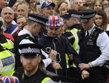 Protesters from climate protest group 'Just Stop Oil' are apprehended by police officers in the crowd close to where Britain's King Charles III will be crowned at Westminster Abbey in London, Saturday, May 6, 2023. (Justin Tallis/Pool Photo via AP)