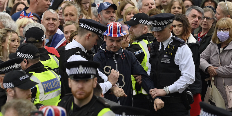 Protesters from climate protest group 'Just Stop Oil' are apprehended by police officers in the crowd close to where Britain's King Charles III will be crowned at Westminster Abbey in London, Saturday, May 6, 2023. (Justin Tallis/Pool Photo via AP)