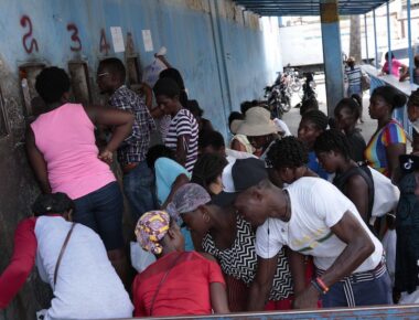 People gather outside the National Penitentiary for their turn to deliver food to their jailed relatives in downtown Port-au-Prince, Haiti, Thursday, June 1, 2023. In December 2022, the University of Florida published a study that found that men in Haiti’s prisons were on a starvation-level diet, consuming fewer than 500 calories a day. (AP Photo/Odelyn Joseph)