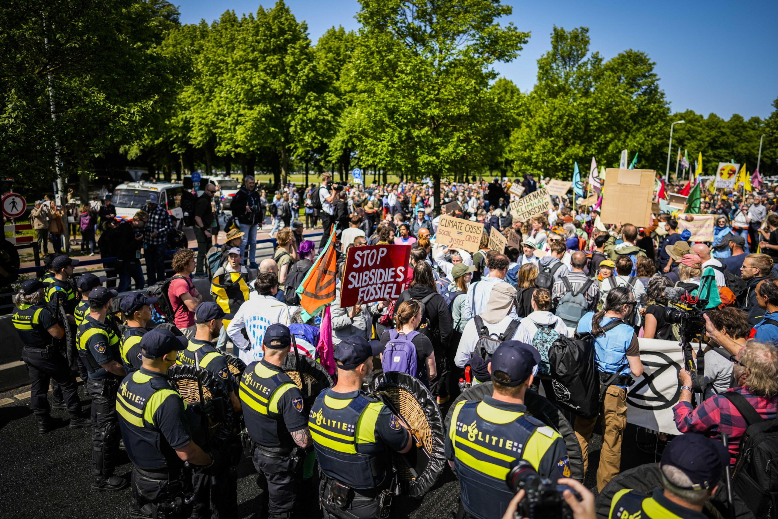 epa10657041 Activists of Extinction Rebellion are stopped by the police during a demonstration to block the A12 for the seventh time, in The Hague, the Netherlands, 27 May 2023. With the action, Extinction Rebellion wants to make the Dutch government know it opposes fossil subsidies. During the most recent blockade on 11 March some 700 activists were arrested.  EPA/Sem van der Wal