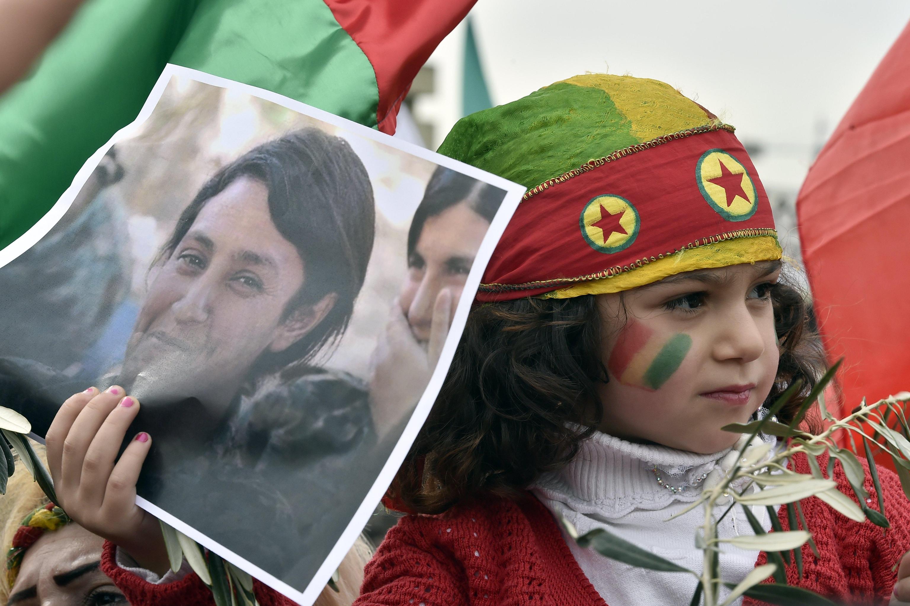 epa06498178 A Kurdish girl carries a picture of late 23-year-old Kurdish People's Protection Units (YPJ) fighter Barin Kobani, during a protest against what they call the 'Turkish aggression' in northern Syria, near the US embassy in Awkar, east of Beirut, Lebanon, 05 February 2018. The Turkish army is on an operation named 'Operation Olive Branch' in Syria's northern regions against the Kurdish Popular Protection Units (YPG) forces which control the city of Afrin. Turkey classifies the YPG as a terrorist organization.  EPA/WAEL HAMZEH