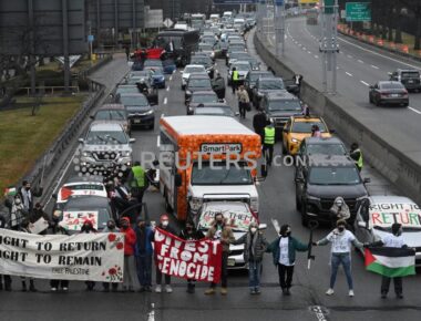 Pro-Palestinian demonstrators block traffic on the road that leads to John F Kennedy airport (JFK), amid the ongoing conflict between Israel and the Palestinian Islamist group Hamas, in New York City, U.S., December 27, 2023. REUTERS/Stephanie Keith