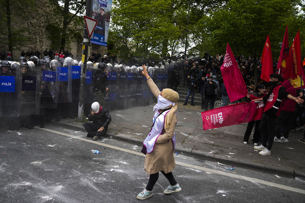 Union members clash with Turkish anti riot police officers as they march during Labor Day celebrations in Istanbul, Turkey, Wednesday, May 1, 2024. Police in Istanbul used tear gas and fired rubber bullets to disperse thousands of people attempting to break through a barricade and reach the city's main square, Taksim, in defiance of a government ban on celebrating May 1 Labor Day at the landmark location. (AP Photo/Khalil Hamra)