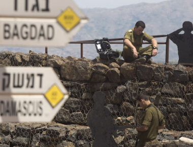 GOLAN HEIGHTS - MAY 10:  (ISRAEL OUT)  Israeli soldier is seen next to a signs pointing out distance to different cities on Mount Bental next to the Syrian border on May 10, 2018 in the Israeli-annexed Golan Heights. Some 20 rockets were fired at Israeli military bases by Iranian forces from southern Syria just after midnight on Thursday, sparking the largest ever direct clash between Jerusalem and Tehran, with Israeli jets targeting numerous Iranian-controlled sites across Syria. On Monday  U.S. President Donald Trump pulls out of the Iran deal.  (Photo by Lior Mizrahi/Getty Images)