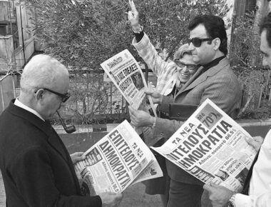 Athenians reading newspaper banner on the landslide defeat of the monarchy in Sunday's Plebiscite, December 9, 1974. Foreground headlines read. "Democracy at Last." (AP Photo)