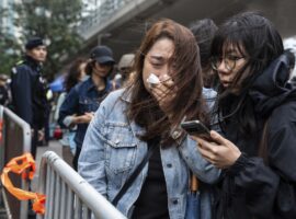 People leave the West Kowloon Magistrates' Courts in Hong Kong Tuesday, Nov. 19, 2024, following the sentencing in national security case. (AP Photo/Chan Long Hei)