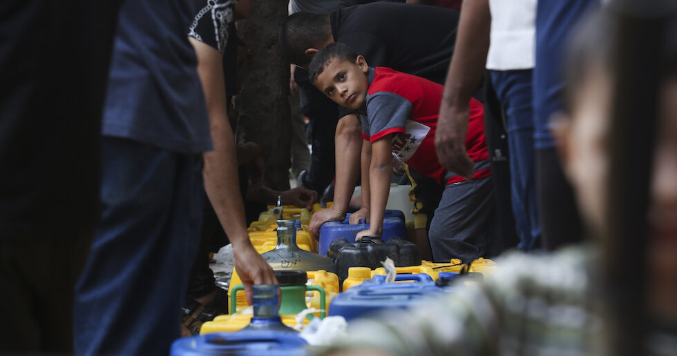 Palestinians arrive to collect drinking water during the ongoing Israeli bombardment of the Gaza Strip in Rafah on Saturday, Oct. 28, 2023. (AP Photo/Hatem Ali)