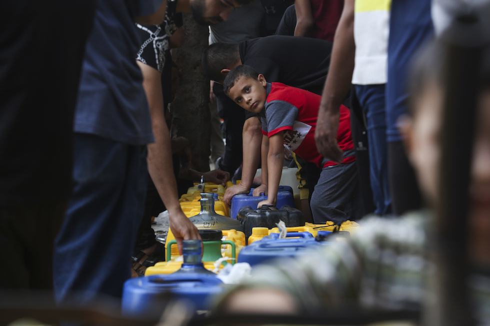 Palestinians arrive to collect drinking water during the ongoing Israeli bombardment of the Gaza Strip in Rafah on Saturday, Oct. 28, 2023. (AP Photo/Hatem Ali)